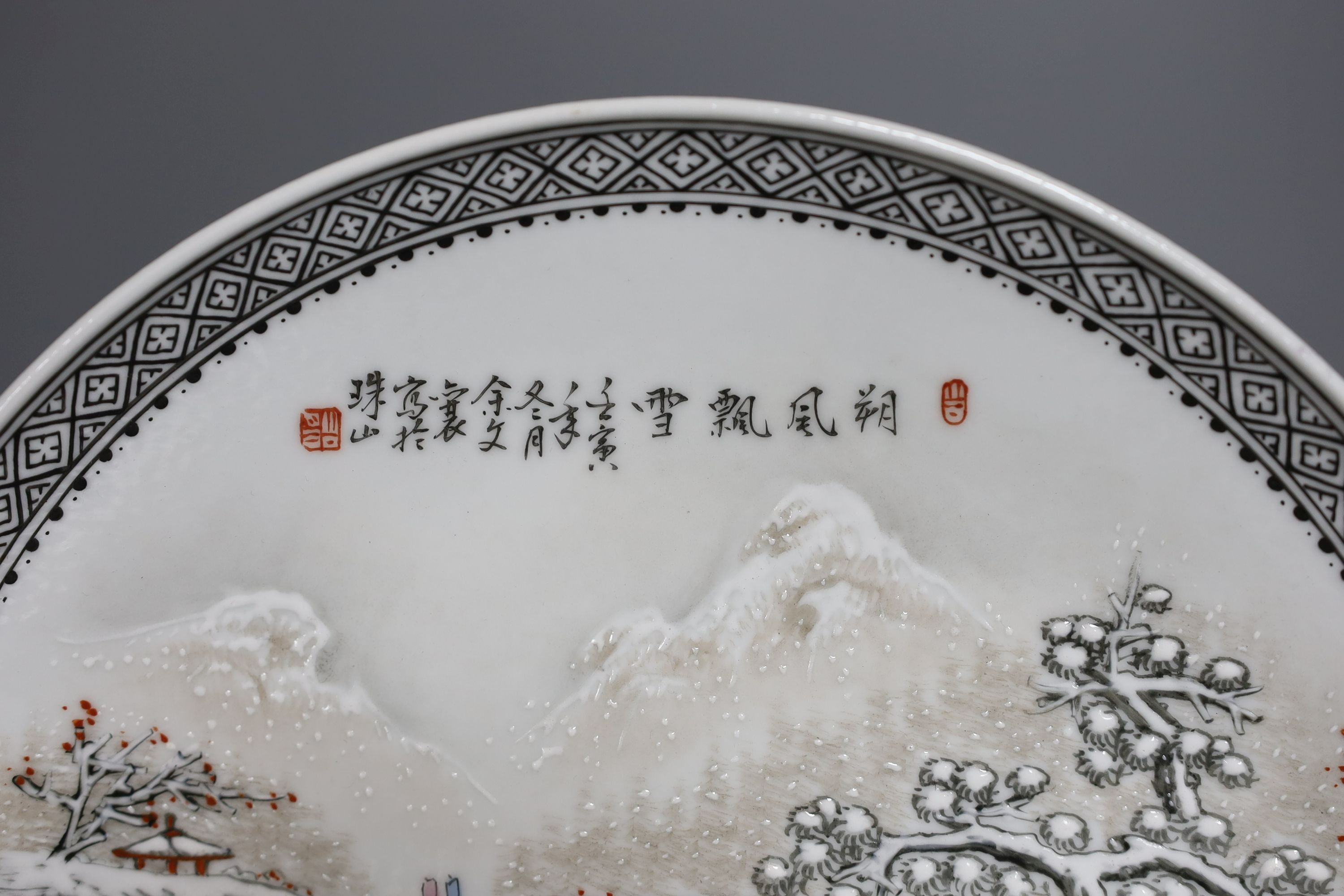 A Chinese famille rose plate depicting a winter scene - 27cm diameter